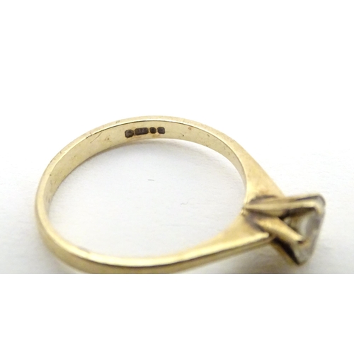 588 - A 9ct gold ring set with white stone solitaire. Ring size approx. N