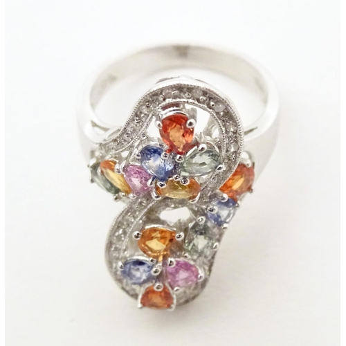 589 - A 18ct white gold dress ring set with various coloured stones. Ring size approx. N 1/2