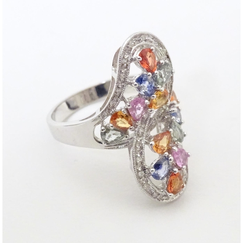 589 - A 18ct white gold dress ring set with various coloured stones. Ring size approx. N 1/2