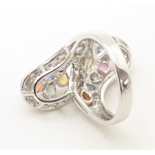 589 - A 18ct white gold dress ring set with various coloured stones. Ring size approx. N 1/2