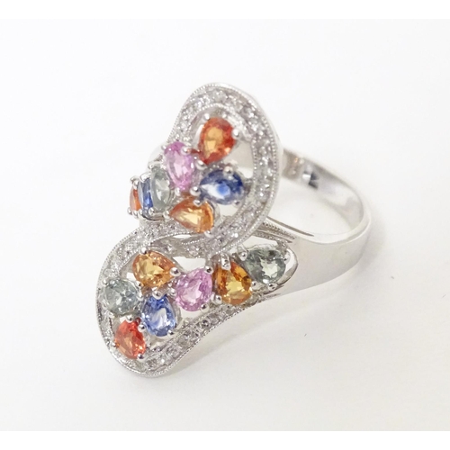 589 - A 18ct white gold dress ring set with various coloured stones. Ring size approx. N 1/2