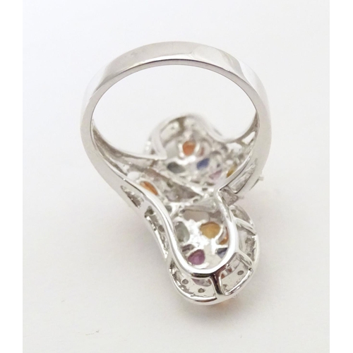 589 - A 18ct white gold dress ring set with various coloured stones. Ring size approx. N 1/2