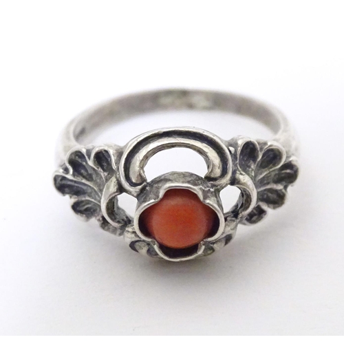 594 - A Continental .800 white metal ring set with coral cabochon. Ring size approx. P