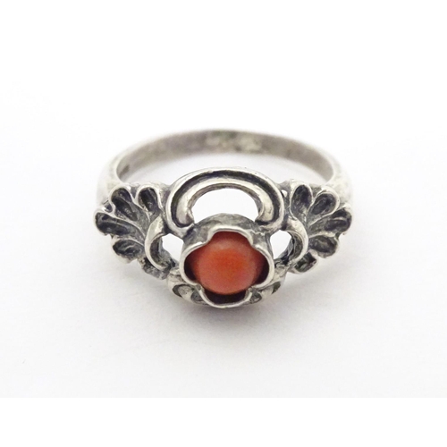 594 - A Continental .800 white metal ring set with coral cabochon. Ring size approx. P