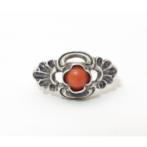 594 - A Continental .800 white metal ring set with coral cabochon. Ring size approx. P