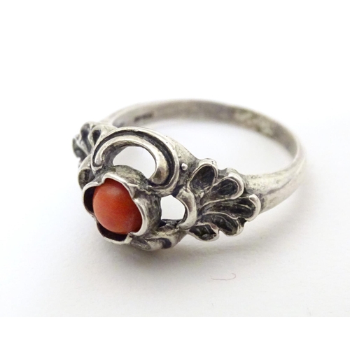 594 - A Continental .800 white metal ring set with coral cabochon. Ring size approx. P