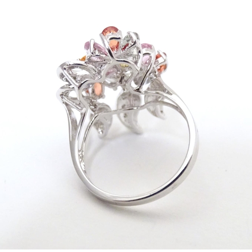 597 - A 18ct white gold dress ring set with various coloured stones. Ring size approx. N