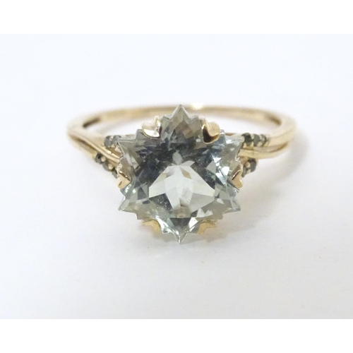 605 - A 9ct gold ring set with central prasiolite flanked by green diamonds, together with a matching pend... 