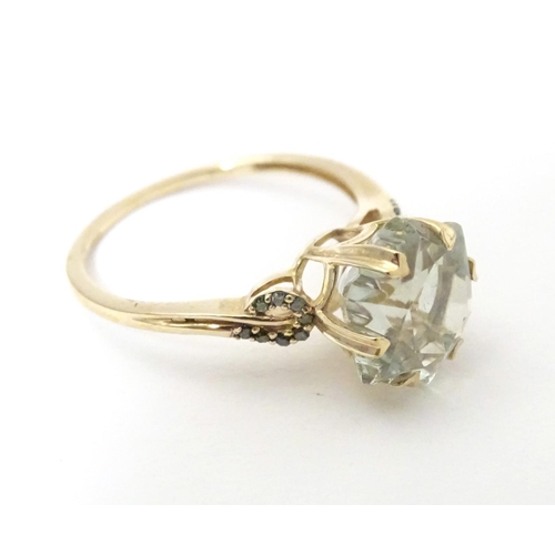 605 - A 9ct gold ring set with central prasiolite flanked by green diamonds, together with a matching pend... 