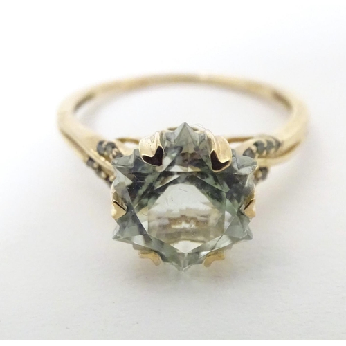 605 - A 9ct gold ring set with central prasiolite flanked by green diamonds, together with a matching pend... 