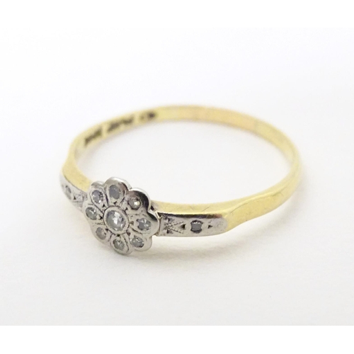 608 - An 18ct gold ring with 12 platinum set diamonds. Ring size approx. Q