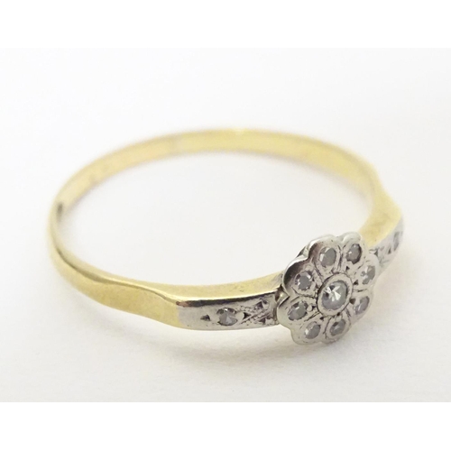 608 - An 18ct gold ring with 12 platinum set diamonds. Ring size approx. Q