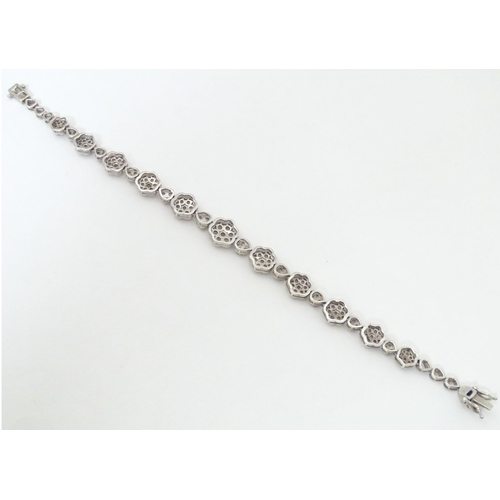 611 - A silver bracelet set with diamonds. Approx 7 1/2