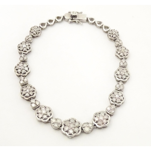 611 - A silver bracelet set with diamonds. Approx 7 1/2