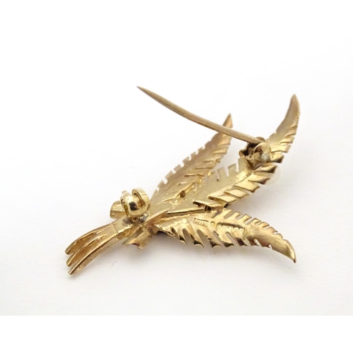 615 - A 9ct gold brooch of foliate sprig form set with garnets and pearls. Aprox 1 3/4