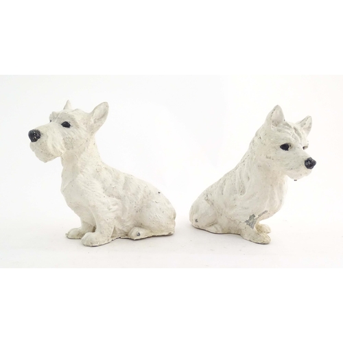 1008 - Two 20thC cast and painted models of seated terrier dogs. Approx. 7 1/2