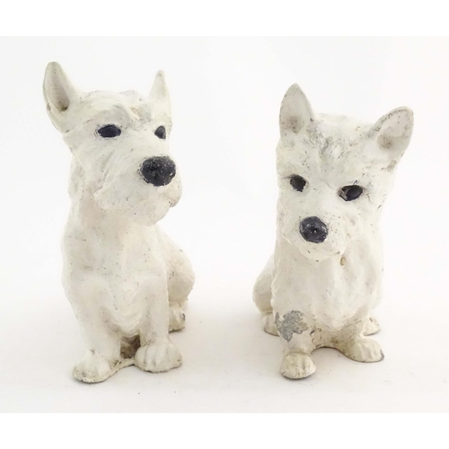 1008 - Two 20thC cast and painted models of seated terrier dogs. Approx. 7 1/2