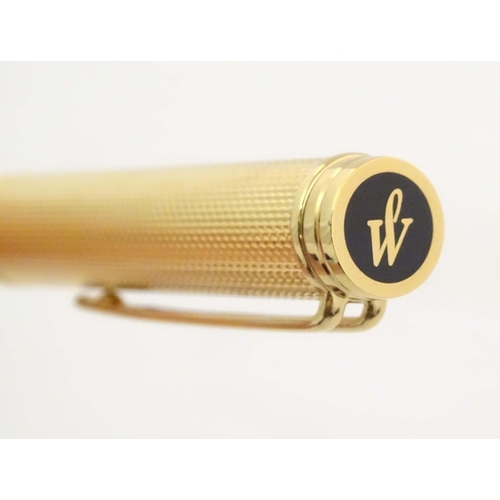 1150 - A cased Waterman, Paris 'Ideal' fountain pen, with engine turned decoration, gold plated finish and ... 