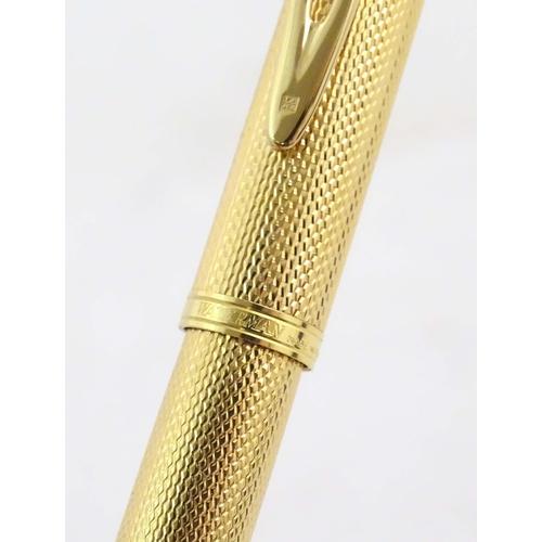 1150 - A cased Waterman, Paris 'Ideal' fountain pen, with engine turned decoration, gold plated finish and ... 