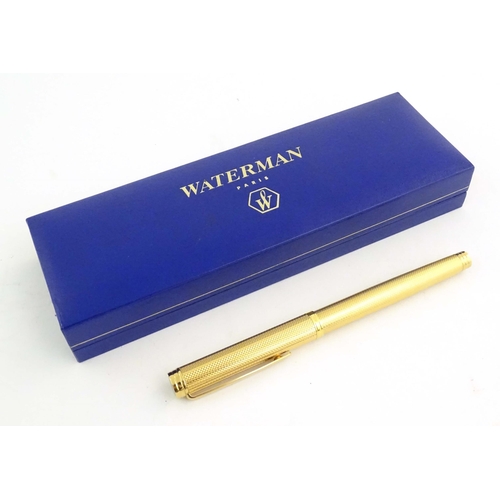 1150 - A cased Waterman, Paris 'Ideal' fountain pen, with engine turned decoration, gold plated finish and ... 