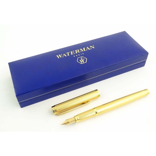 1150 - A cased Waterman, Paris 'Ideal' fountain pen, with engine turned decoration, gold plated finish and ... 