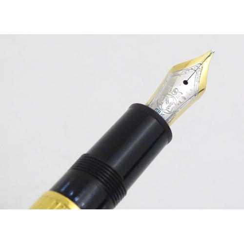 1153 - A cased Montblanc '146 Le Grand' silver gilt fountain pen, with linear decoration and 18K gold nib. ... 