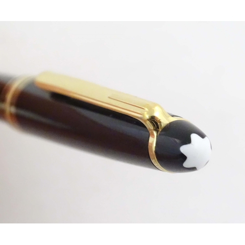 1154 - A cased Montblanc 'Meisterstuck' ballpoint pen, in black finish and decorated with gilt banding. App... 