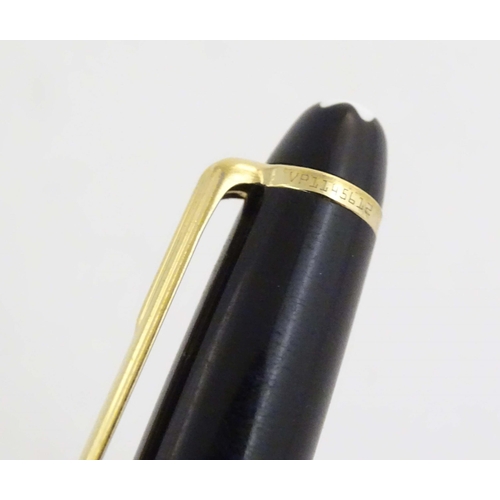 1154 - A cased Montblanc 'Meisterstuck' ballpoint pen, in black finish and decorated with gilt banding. App... 