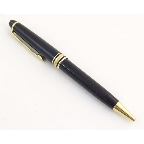 1154 - A cased Montblanc 'Meisterstuck' ballpoint pen, in black finish and decorated with gilt banding. App... 