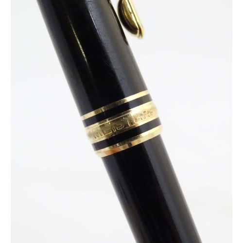 1154 - A cased Montblanc 'Meisterstuck' ballpoint pen, in black finish and decorated with gilt banding. App... 