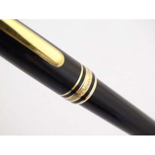 1154 - A cased Montblanc 'Meisterstuck' ballpoint pen, in black finish and decorated with gilt banding. App... 