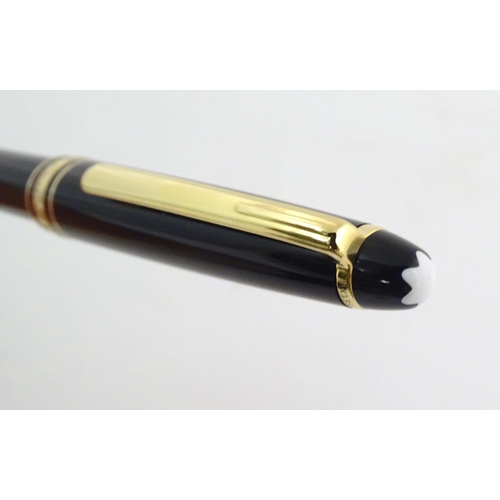 1155 - A cased Montblanc 'Meisterstuck' ballpoint pen, in black finish and decorated with gilt banding. App... 