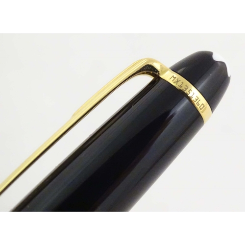 1155 - A cased Montblanc 'Meisterstuck' ballpoint pen, in black finish and decorated with gilt banding. App... 