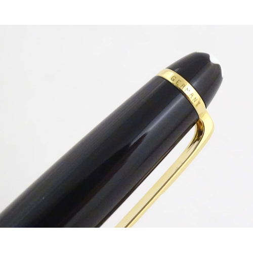 1155 - A cased Montblanc 'Meisterstuck' ballpoint pen, in black finish and decorated with gilt banding. App... 