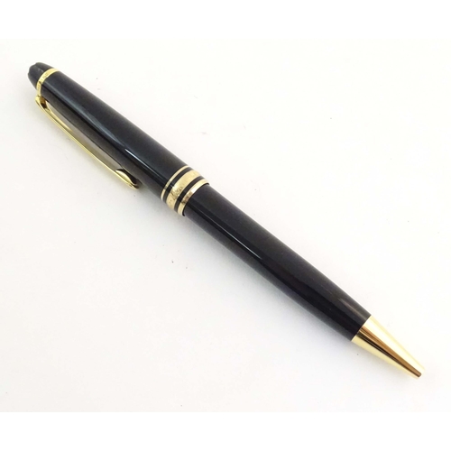 1155 - A cased Montblanc 'Meisterstuck' ballpoint pen, in black finish and decorated with gilt banding. App... 