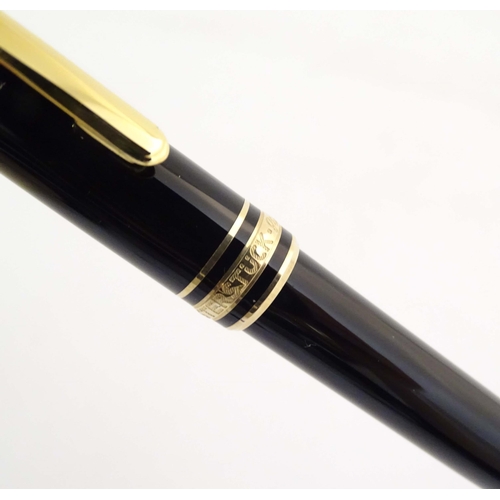 1155 - A cased Montblanc 'Meisterstuck' ballpoint pen, in black finish and decorated with gilt banding. App... 