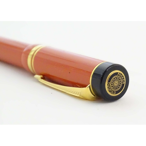 1156 - A presentation cased Parker Duofold medium fountain pen, in pink finish with black mounts, decorated... 