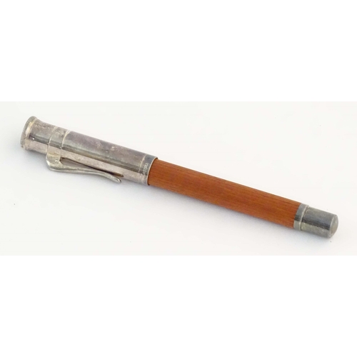 1157 - A cased Graf von Faber-Castell ballpoint pen, with reeded hardwood grip and articulated clip. Approx... 