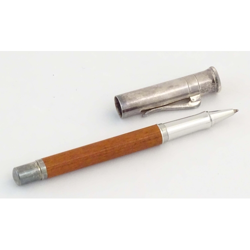 1157 - A cased Graf von Faber-Castell ballpoint pen, with reeded hardwood grip and articulated clip. Approx... 