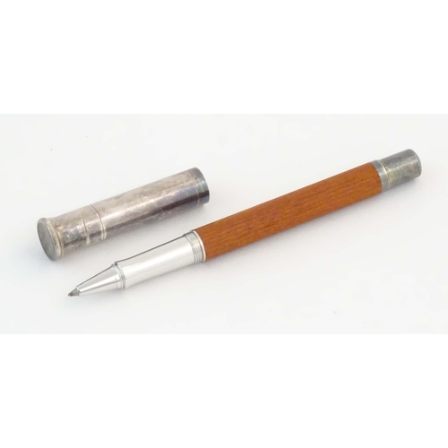 1157 - A cased Graf von Faber-Castell ballpoint pen, with reeded hardwood grip and articulated clip. Approx... 