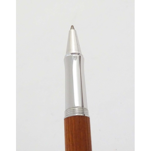 1157 - A cased Graf von Faber-Castell ballpoint pen, with reeded hardwood grip and articulated clip. Approx... 