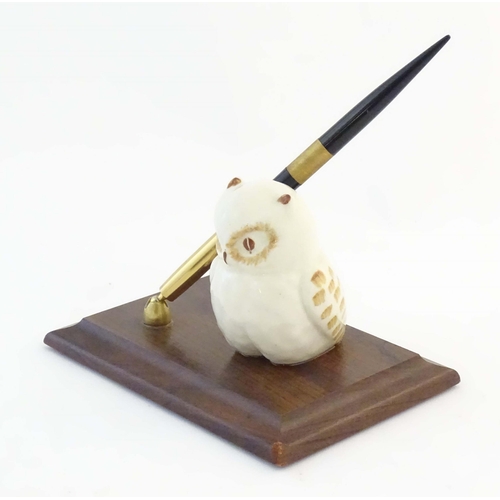 1161 - A late 20th / early 21stC pen holder with ceramic owl on a wooden base. Approx. 6