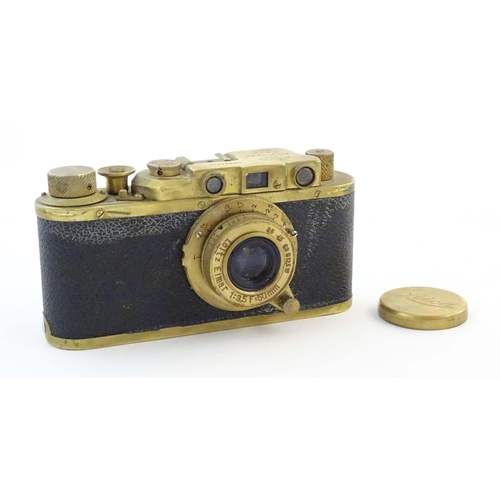 1164 - A mid 20thC Russian copy 'Leica II(D) Olympiada' 35mm film camera, in gilt finish and leather case, ... 