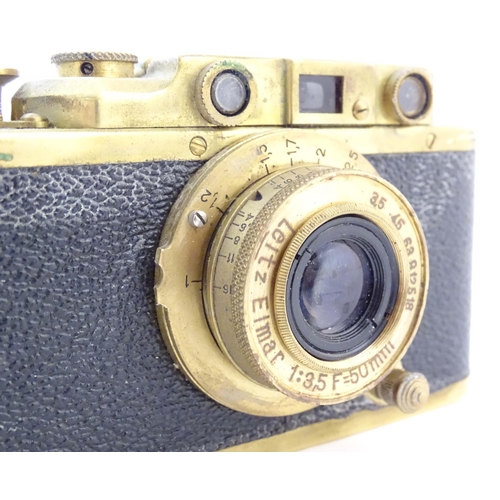 1164 - A mid 20thC Russian copy 'Leica II(D) Olympiada' 35mm film camera, in gilt finish and leather case, ... 