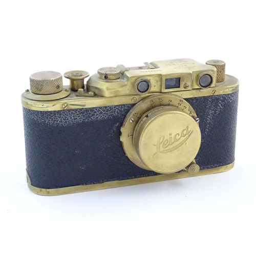 1164 - A mid 20thC Russian copy 'Leica II(D) Olympiada' 35mm film camera, in gilt finish and leather case, ... 