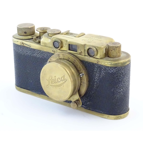 1164 - A mid 20thC Russian copy 'Leica II(D) Olympiada' 35mm film camera, in gilt finish and leather case, ... 