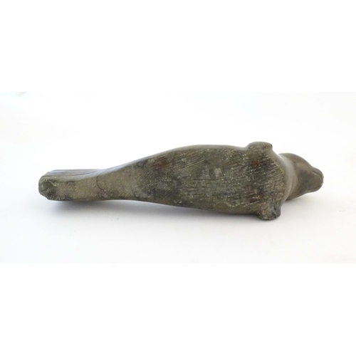 1172 - A 20thC Canadian Inuit carved soapstone model of a seal. Approx. 13 1/2