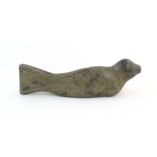 1172 - A 20thC Canadian Inuit carved soapstone model of a seal. Approx. 13 1/2