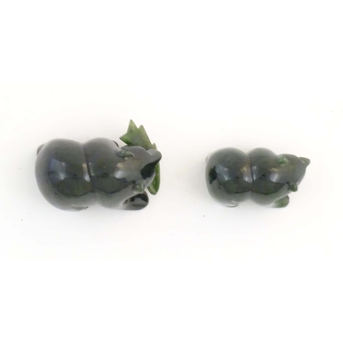 1173 - Two carved jade coloured hardstone models of bears, one with a fish in its mouth. Largest approx. 2 ... 