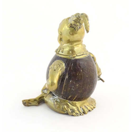 1187 - An early 20thC novelty brass and coconut inkwell modelled as a seated man wearing a plume hat. Appro... 